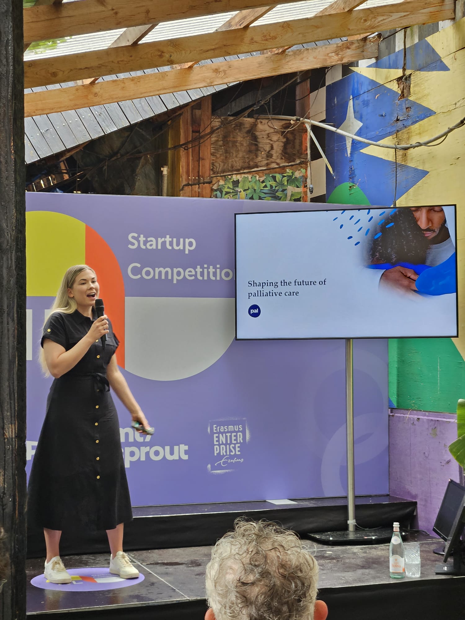 Pal's co-founder Nara Moripen pitching on stage.